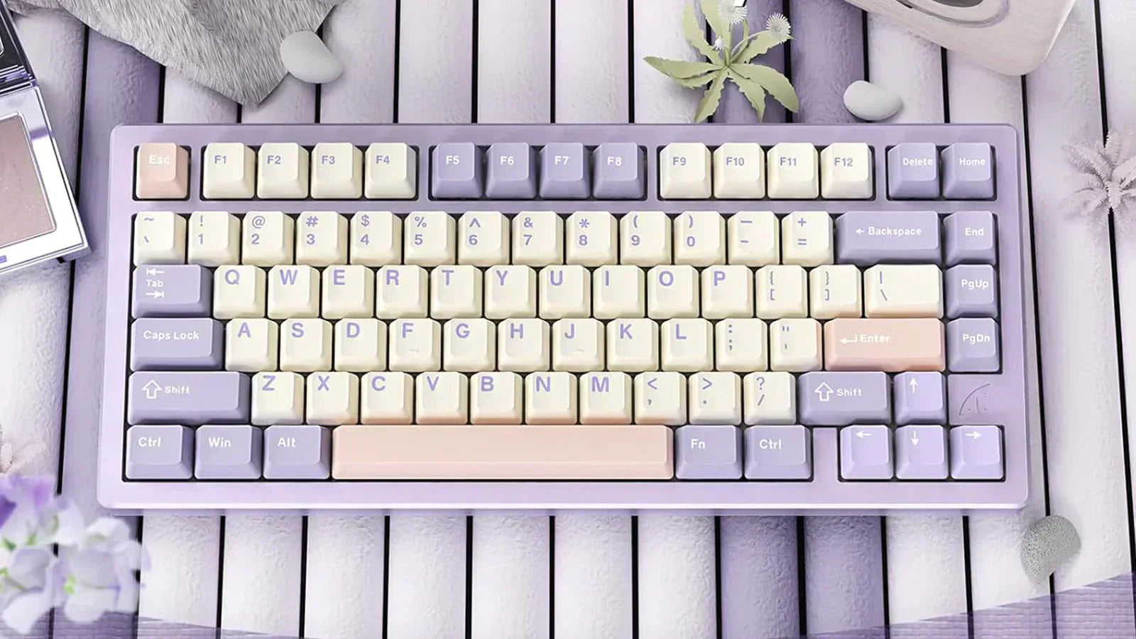 A compact mechanical keyboard with a pastel color scheme featuring light purple and cream keycaps. The keyboard has a 75% layout with function keys and arrow keys.