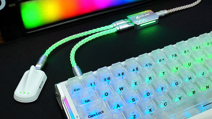 ATTACK SHARK magnetic keyboard cable with glowing green braided cord connected to a translucent mechanical keyboard